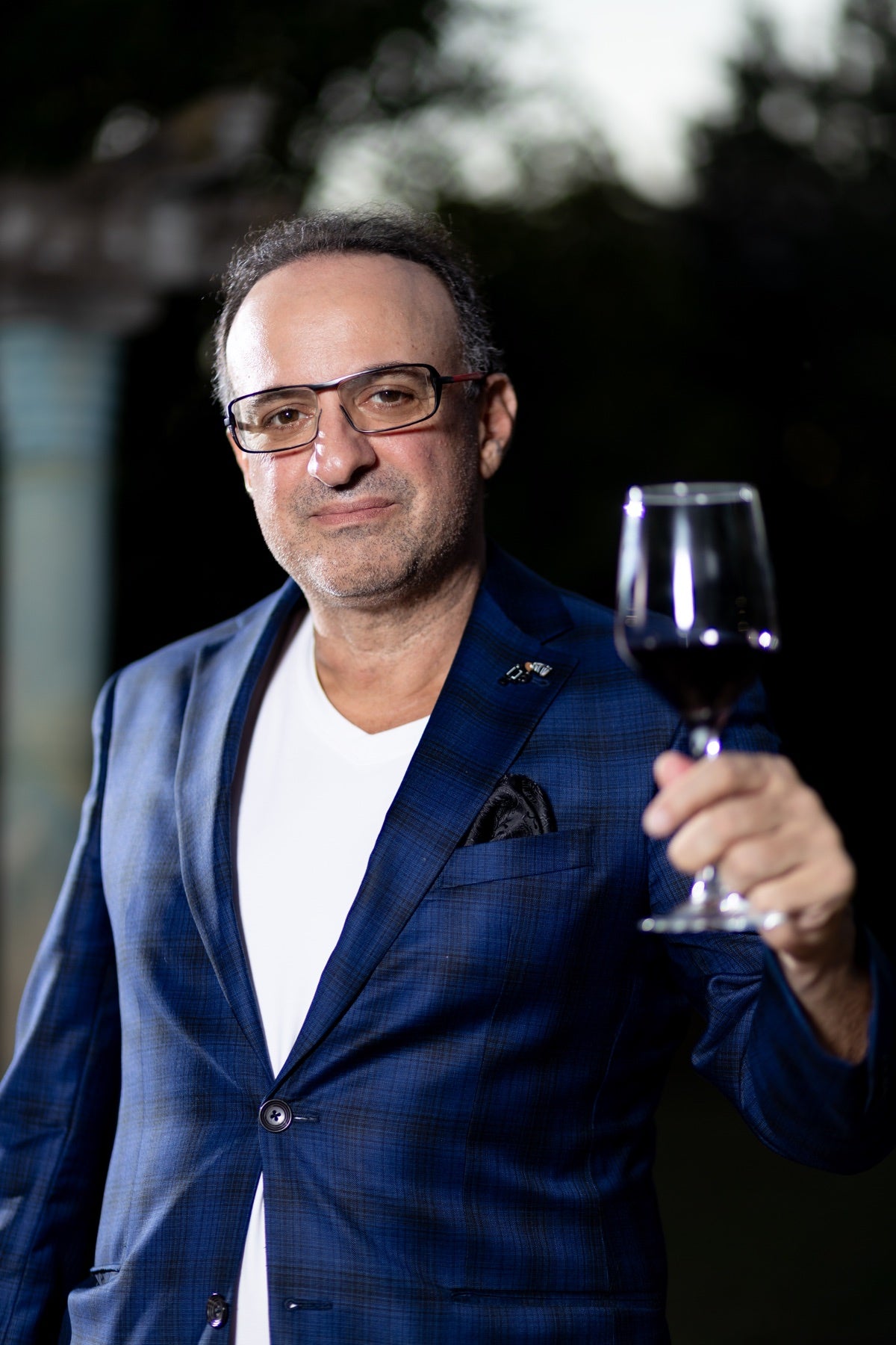 La Pistolina founder Michael Giordano raising a glass of red wine